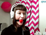 Ball gag girl at office desk
