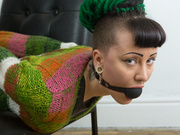Ball gagged and hogtied across the chair