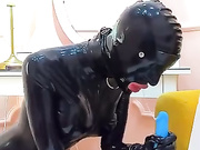Latex slavegirl sucks to please