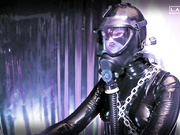 girl in a gas mask attached oxygen tank riding bicycle